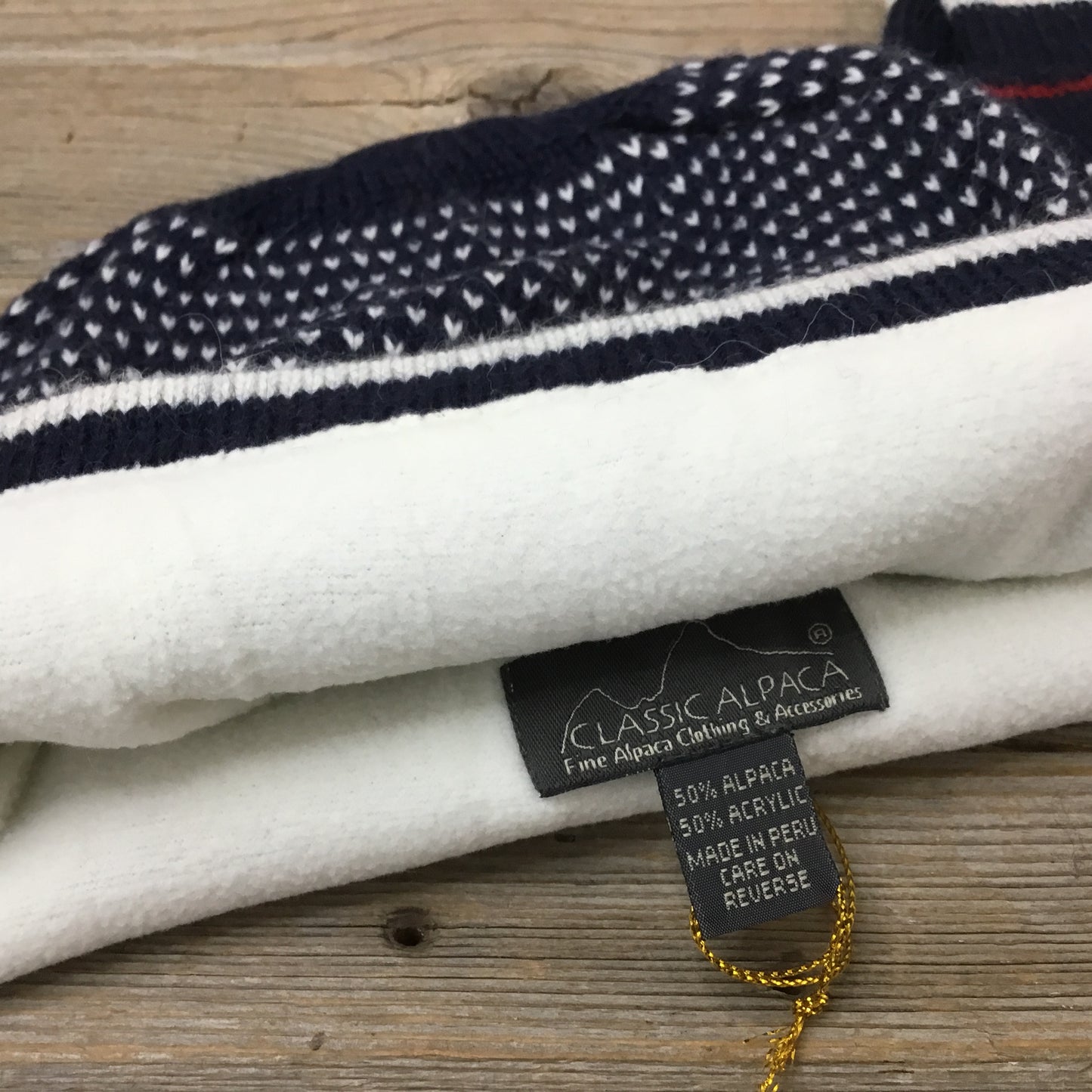 Close-up of fleece lining inside alpaca snowflake hat navy red