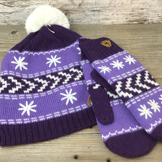 A set of purple alpaca wool hat and mittens with white geometric patterns, displayed on a wooden surface.