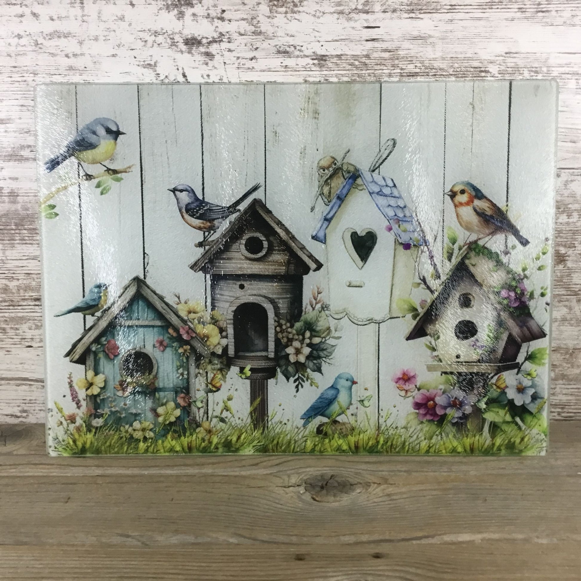 Birds, Flowers & Bird Houses on a glass cutting board