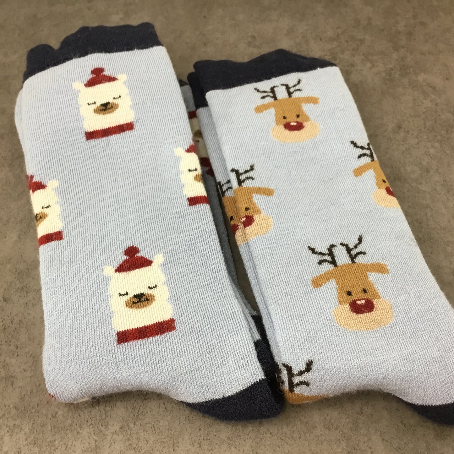 Two pairs of socks with reindeer and alpaca designs 