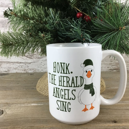 Honk the Herald Angels Sing Goose 15 oz Ceramic Coffee Mug in front of Christmas tree