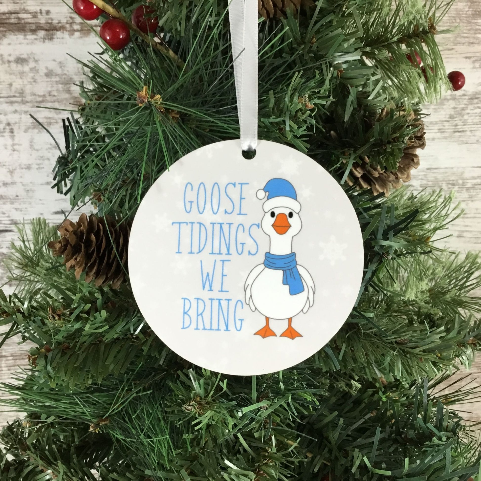 Christmas ornament with a goose design and text 'GOOSE TIDINGS WE BRING' on a tree