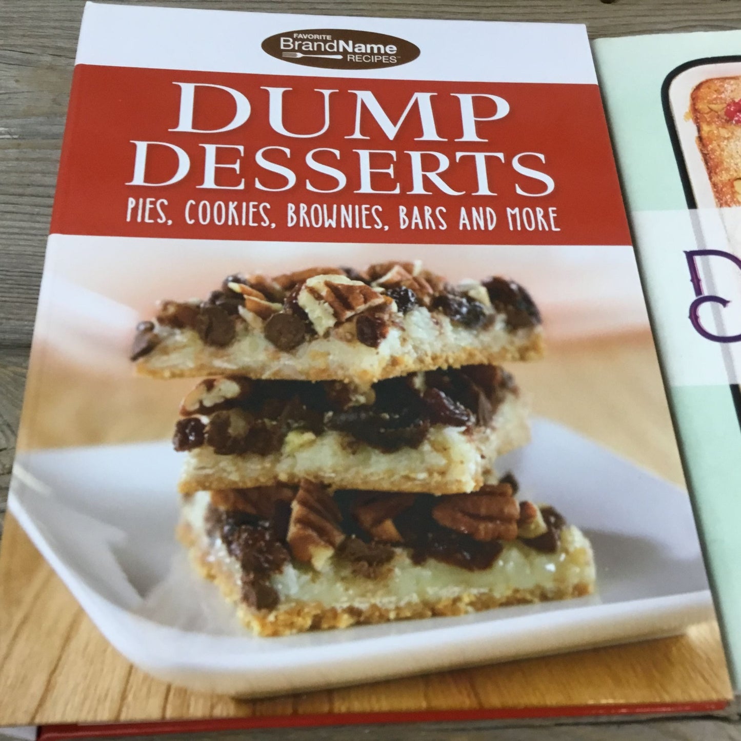 Cookbook titled 'Dump Desserts' with a stack of dessert bars on the cover.